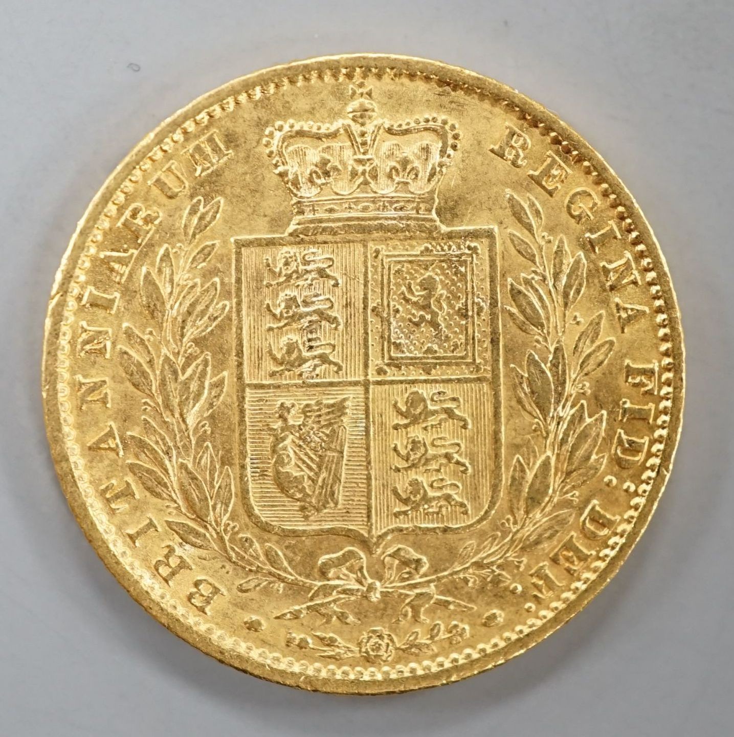 A Victorian 1861 gold young head shield back sovereign, London Mint (1 over lower 1).